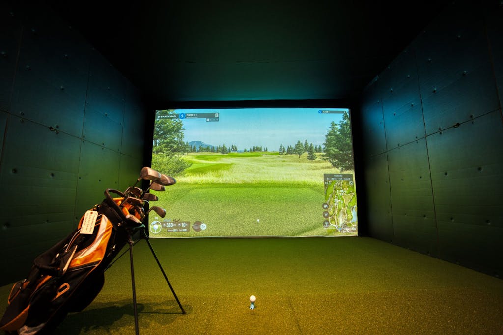 A modern indoor golf simulator with realistic course graphics, located in Mississauga, Canada.